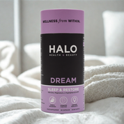 HALO supplement canister on a white blanket with a blurred background