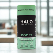 Halo Health & Beauty supplement canister on a blurred indoor background